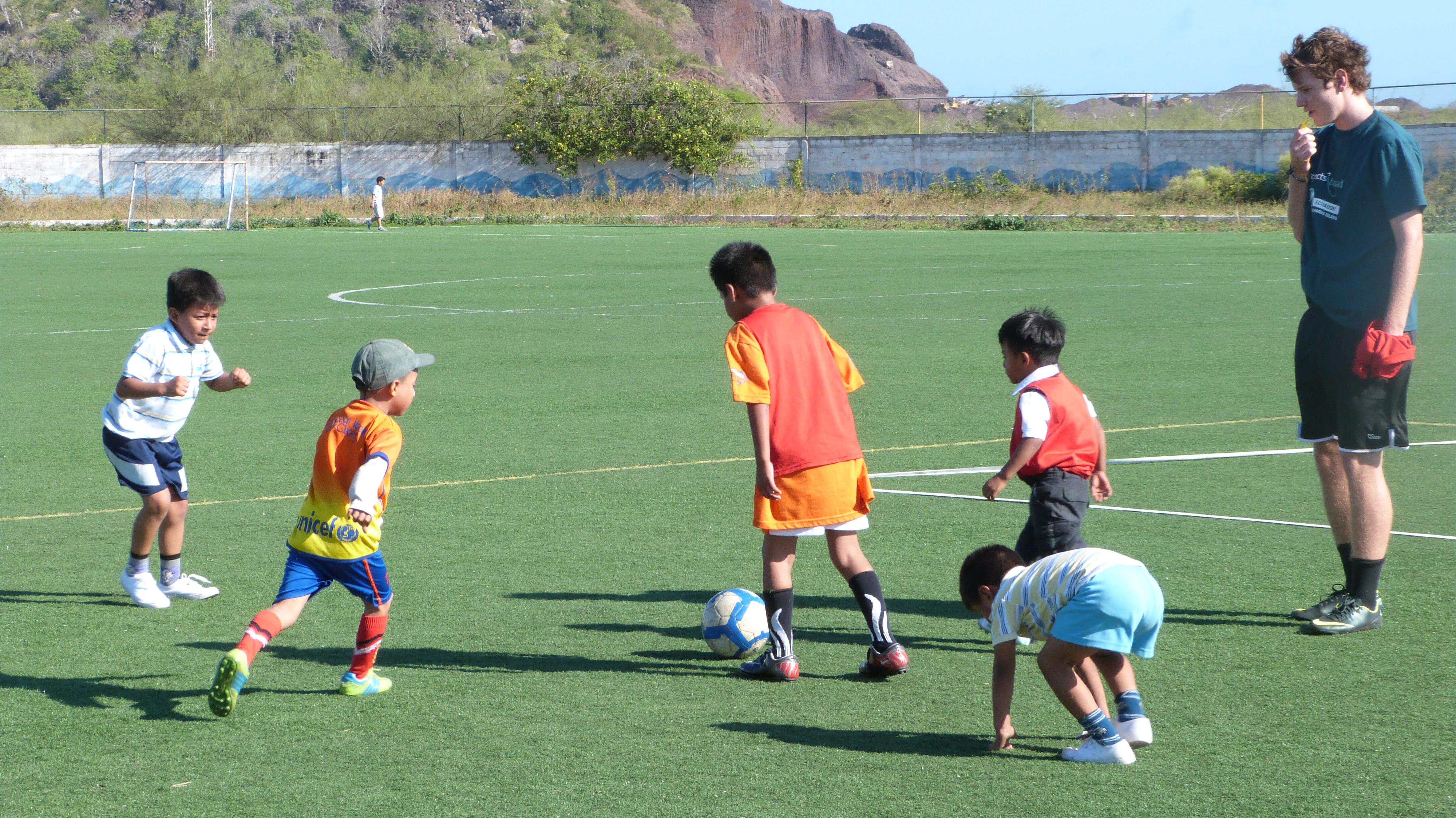 A Projects Abroad volunteer gains hands-on sports coaching experience in Ecuador playing football A sports instructor volunteers as a sports coach in Ecuador and leads a football practice